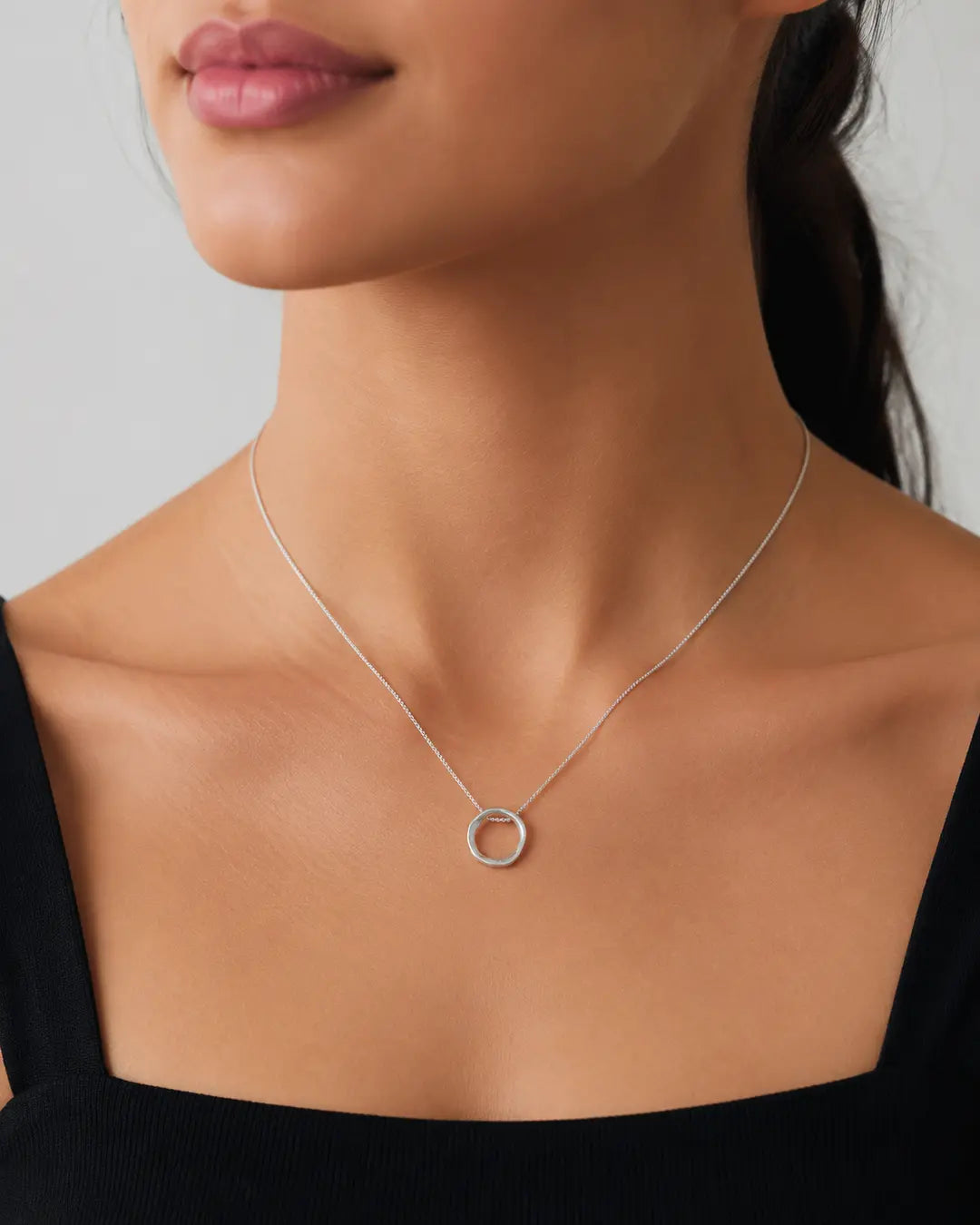 Model wearing the Organic Circle Pendant Necklace in rhodium-filled finish
