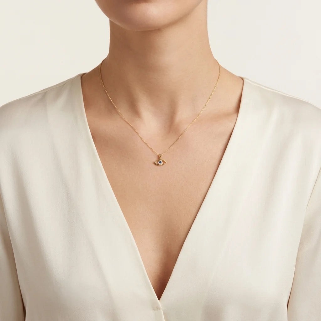 14K yellow gold natural sapphire and diamond eye pendant shown on necklace