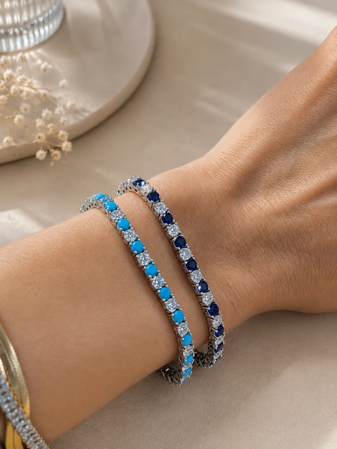 Turquoise and sapphire 3mm CZ tennis bracelets shown on wrist