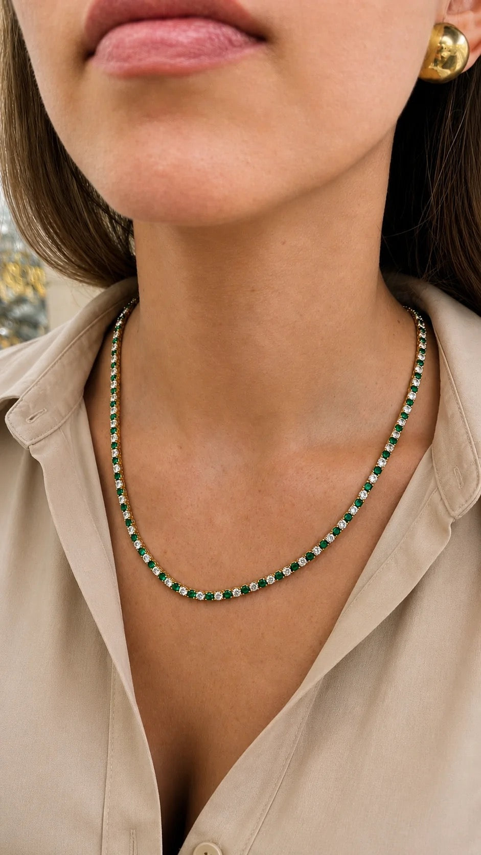 Gold-finished emerald and clear CZ tennis necklace shown on model