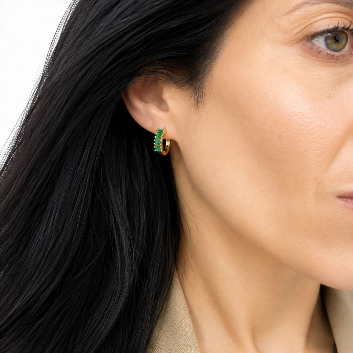 Emerald baguette CZ huggie earrings worn on ear