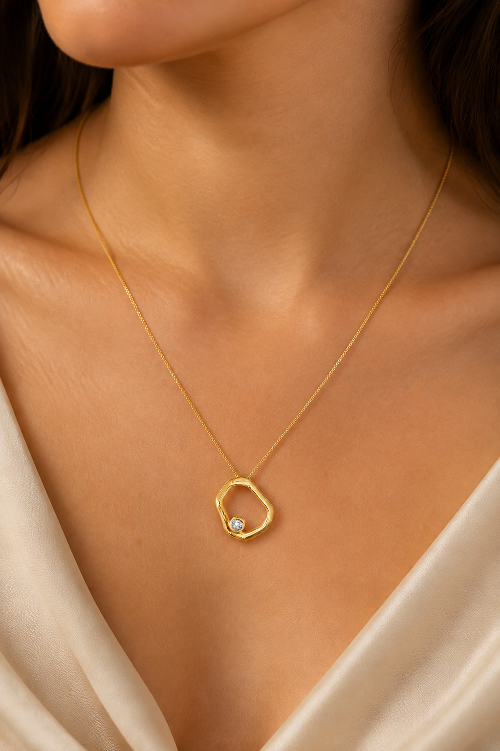 Geometric open circle pendant necklace in gold-filled finish worn by a model