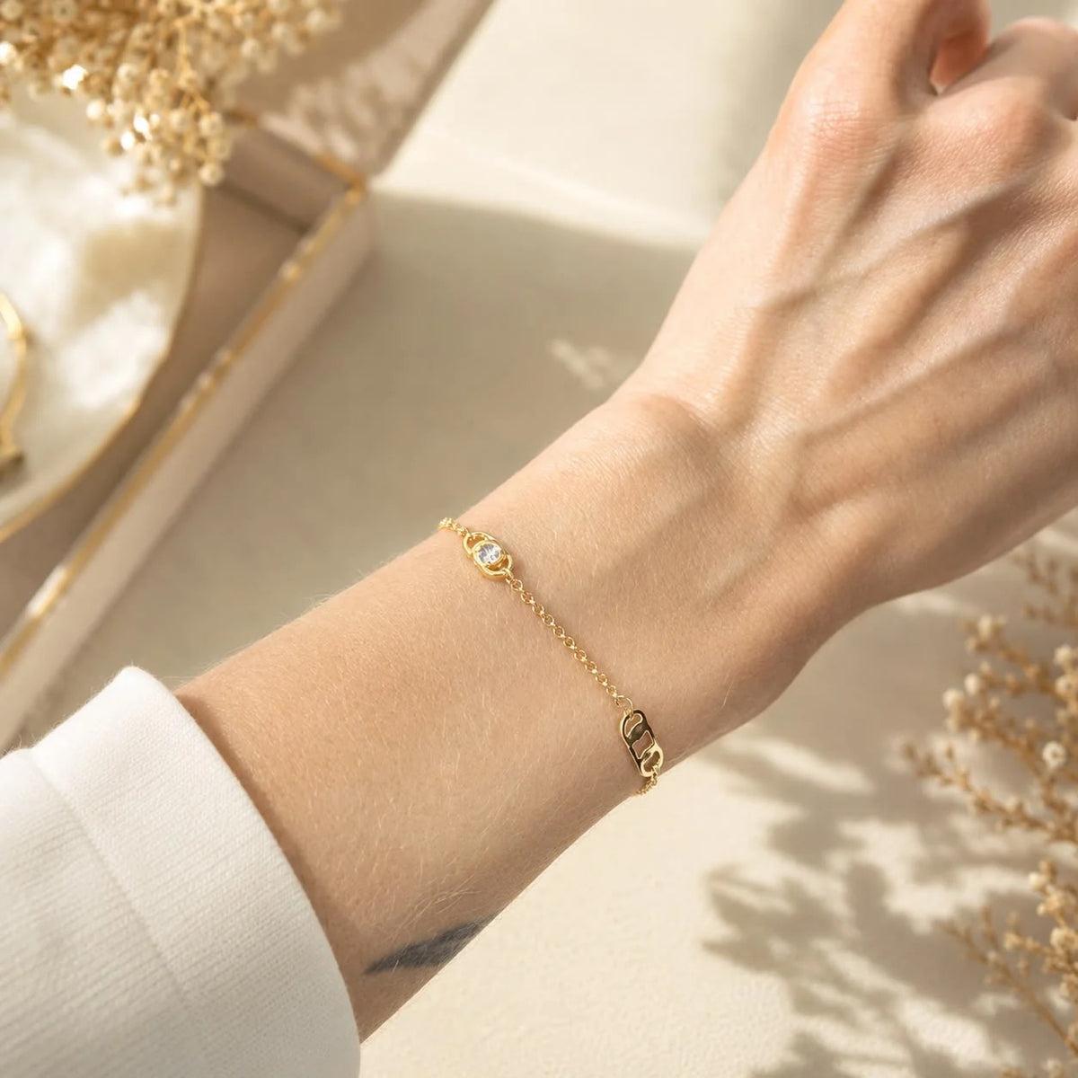 Geometric link and bezel cubic zirconia station bracelet worn on wrist