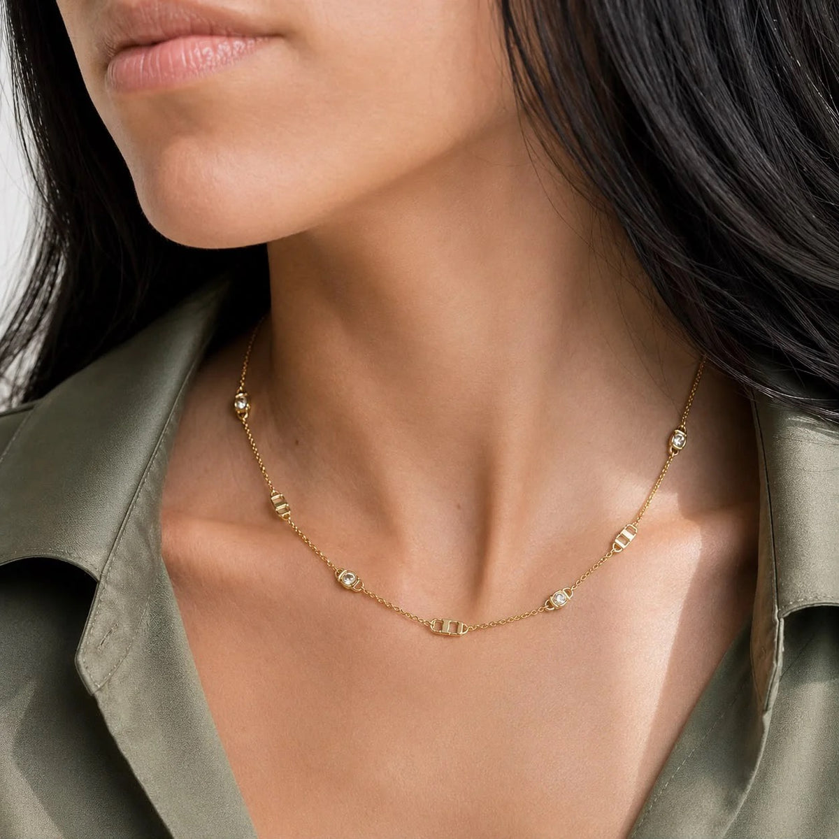 Geometric link and bezel cubic zirconia station necklace worn on neck