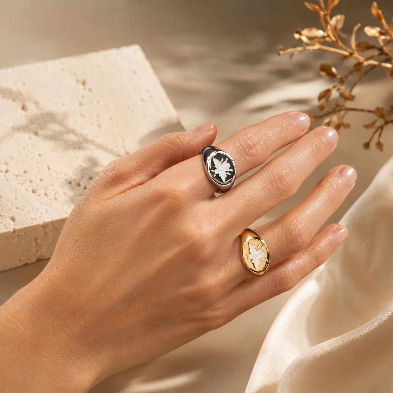 Gold and rhodium mother of pearl bee signet rings worn on hand