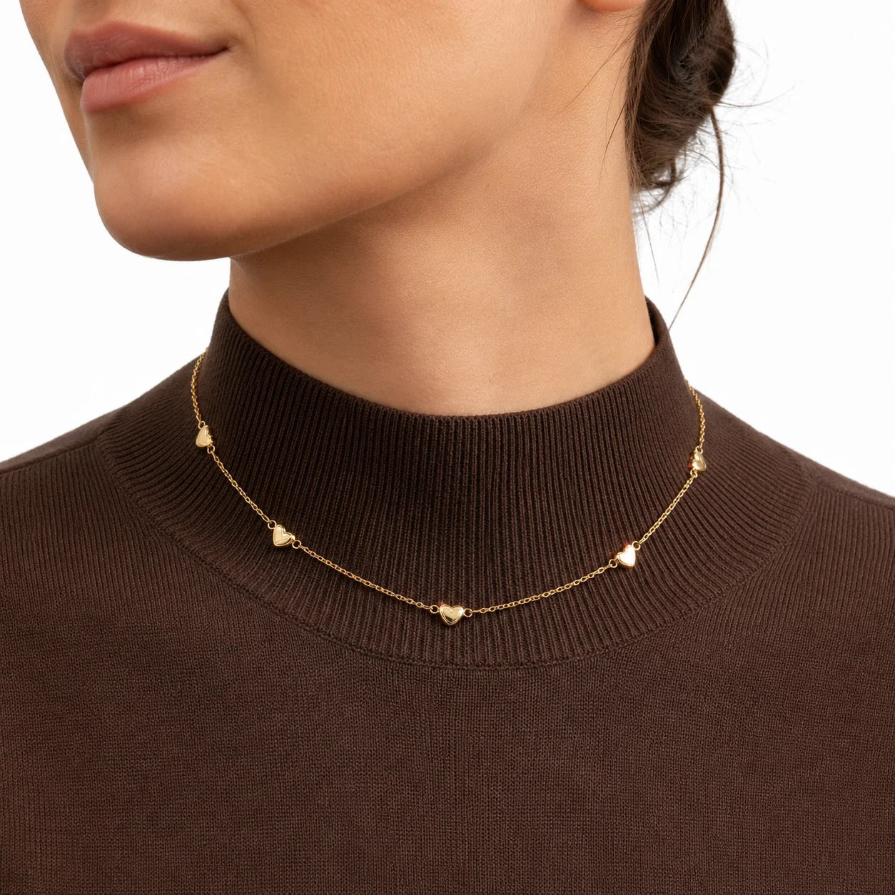 Multi heart station necklace worn on model